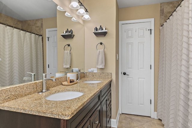 bathroom with tile patterned floors, double vanity, a shower with shower curtain, and a sink