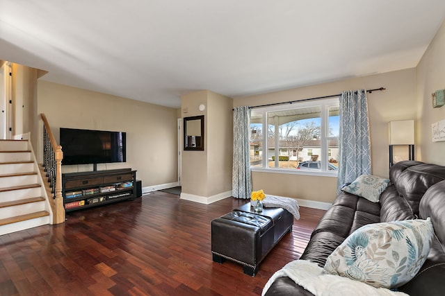 living room featuring stairs, wood finished floors, and baseboards