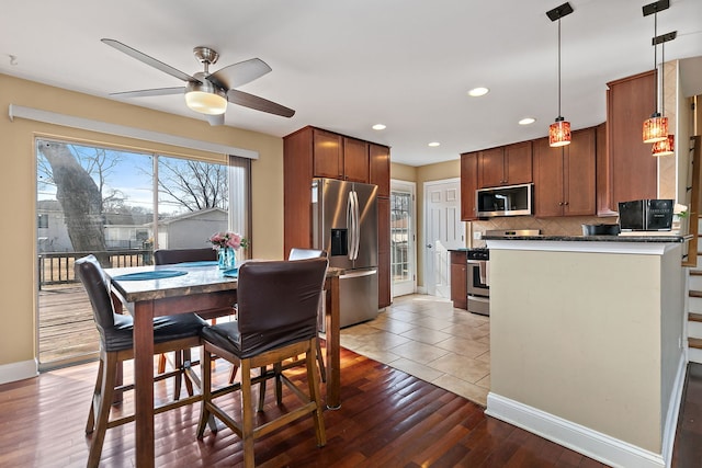 dining space featuring recessed lighting, baseboards, a ceiling fan, and light wood finished floors