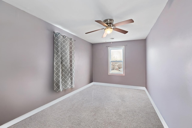 spare room featuring carpet flooring, a ceiling fan, and baseboards