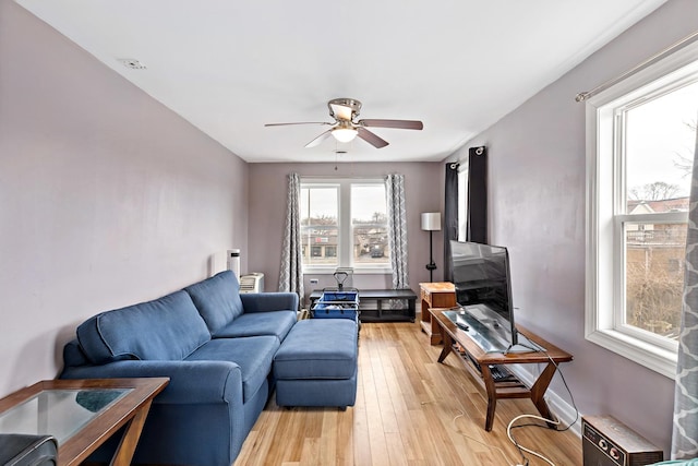 living area featuring a ceiling fan and light wood-type flooring