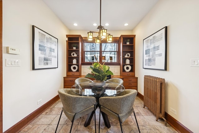 dining room featuring a chandelier, recessed lighting, baseboards, radiator heating unit, and stone tile flooring