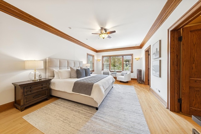 bedroom with light wood finished floors, radiator heating unit, ornamental molding, ceiling fan, and baseboards