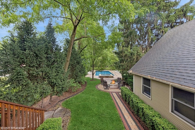 view of yard with a patio area, an outdoor pool, and a fire pit