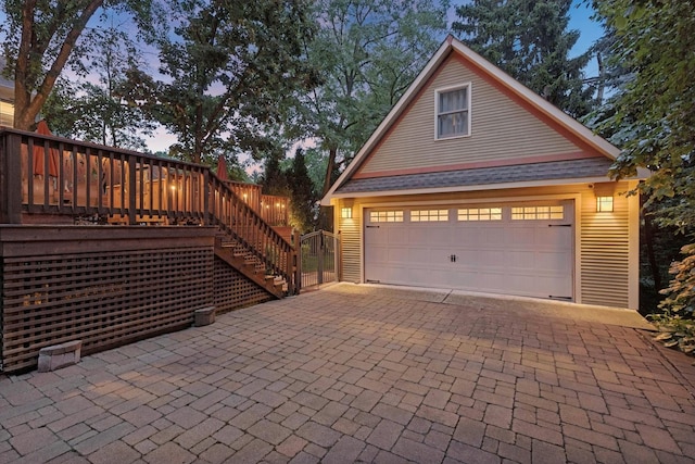 view of garage at dusk