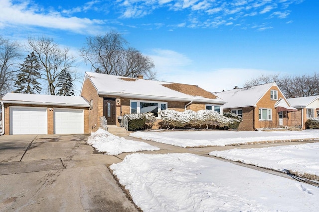 view of front of house featuring driveway, an attached garage, a chimney, and brick siding