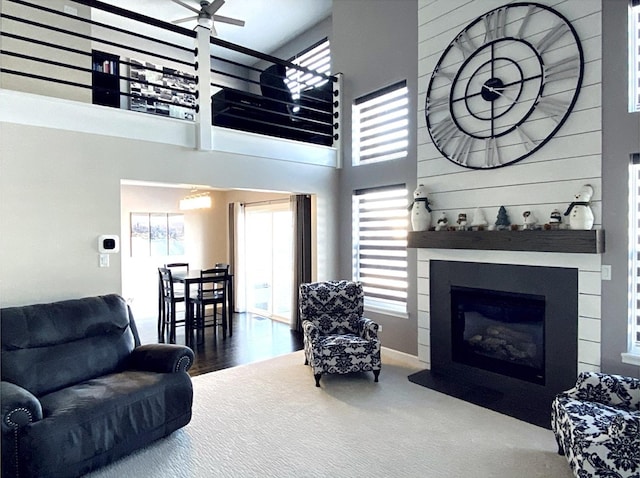 living room with a large fireplace and a high ceiling