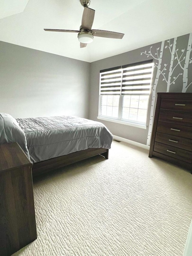 bedroom featuring carpet floors, ceiling fan, visible vents, and baseboards