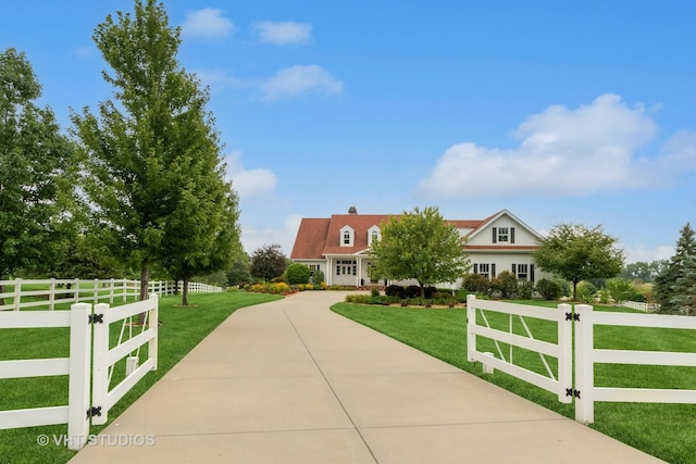 view of front of house with fence and a front lawn