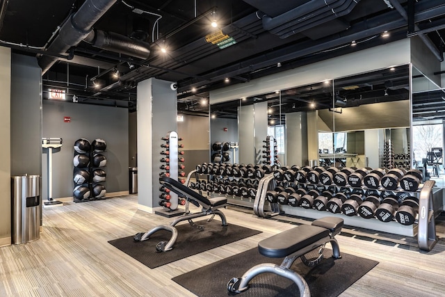 gym featuring wood finished floors and baseboards