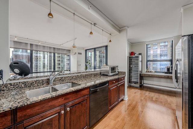 kitchen featuring wine cooler, black dishwasher, light wood-style floors, freestanding refrigerator, and a sink