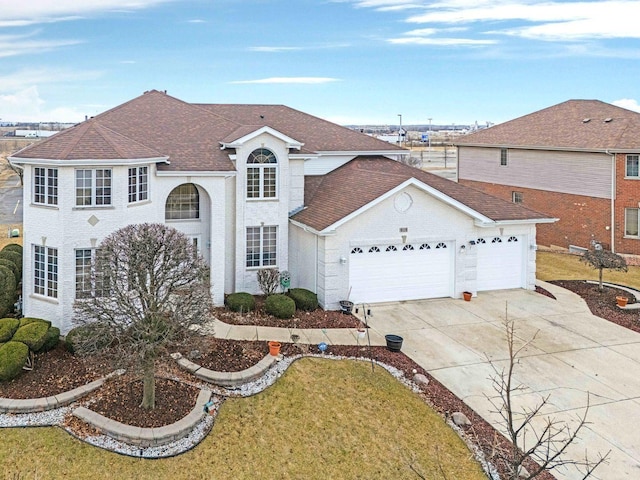 view of front facade featuring an attached garage, driveway, a front yard, and roof with shingles