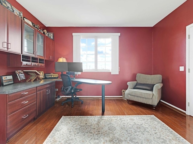 home office with dark wood-style floors and baseboards