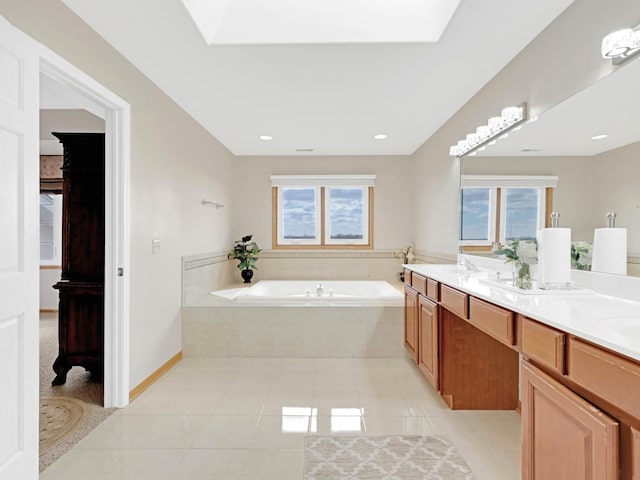 bathroom with a skylight, tile patterned flooring, and a wealth of natural light