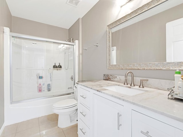 bathroom featuring visible vents, bath / shower combo with glass door, toilet, tile patterned flooring, and vanity