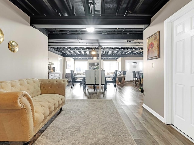 living room with baseboards and wood finished floors