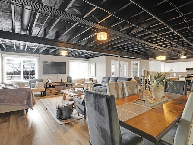 dining space featuring plenty of natural light and wood finished floors