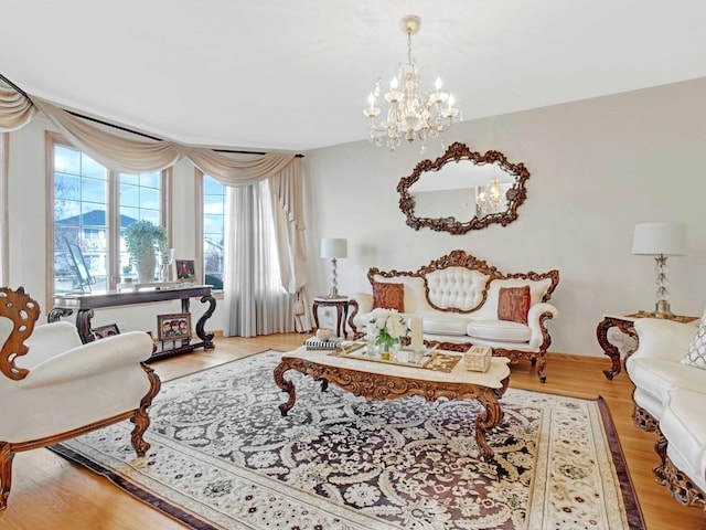 living room with an inviting chandelier and wood finished floors