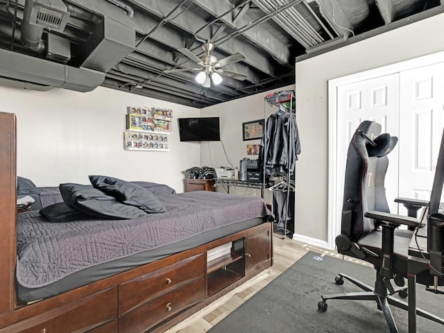 bedroom featuring light wood-style floors and baseboards