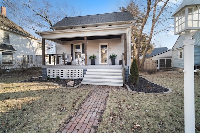 view of front of home featuring covered porch and a shingled roof