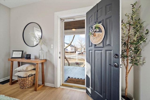 entrance foyer with visible vents, light wood-style flooring, and baseboards