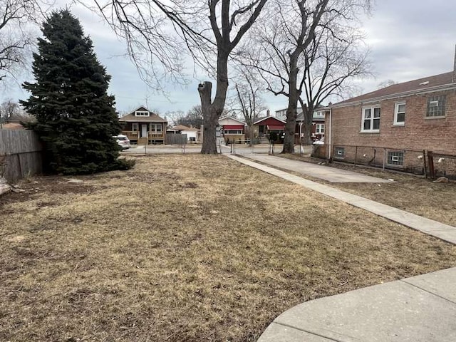 view of yard featuring a residential view and fence