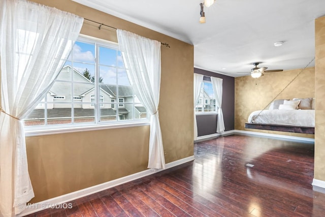 unfurnished bedroom with wood-type flooring and baseboards