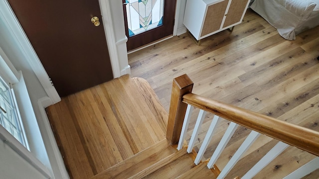 stairs featuring hardwood / wood-style flooring