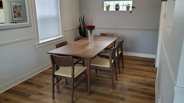 dining area with wood finished floors and baseboards