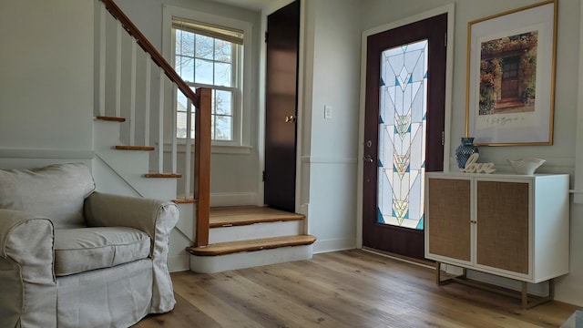 foyer with stairs and wood finished floors