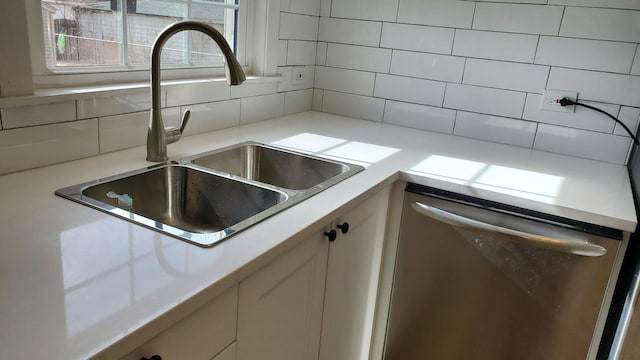 kitchen with a sink, decorative backsplash, dishwasher, and light countertops