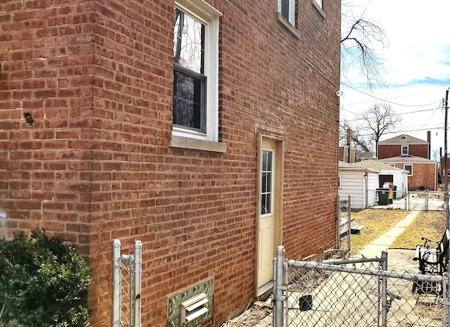 view of side of property with fence and brick siding