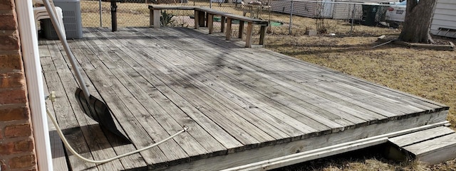 wooden deck with central AC unit and fence