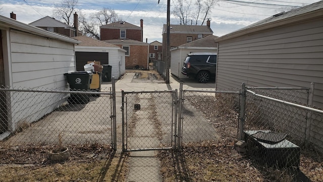 view of yard featuring an outdoor structure, fence, and a gate