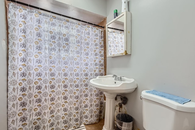 bathroom with toilet, tile patterned flooring, and a shower with shower curtain