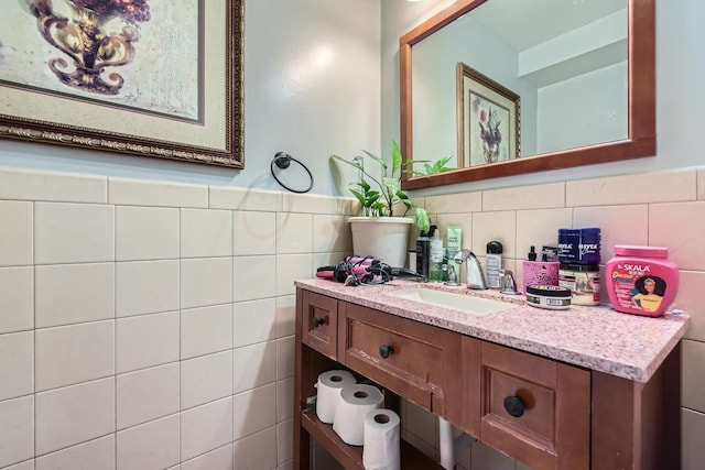 bathroom with wainscoting, tile walls, and vanity
