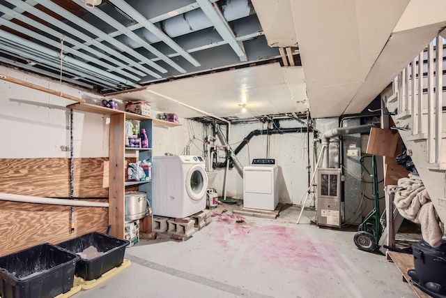unfinished basement with washing machine and clothes dryer
