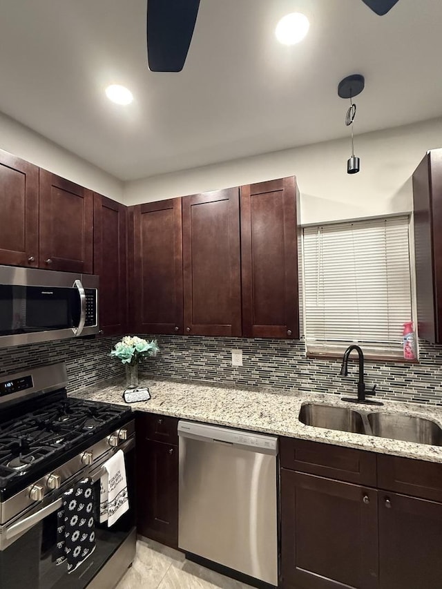 7929 S Manistee Ave, Chicago, IL 60617 - kitchen featuring appliances with stainless steel finishes, tasteful backsplash, light stone counters, dark brown cabinets, and recessed lighting