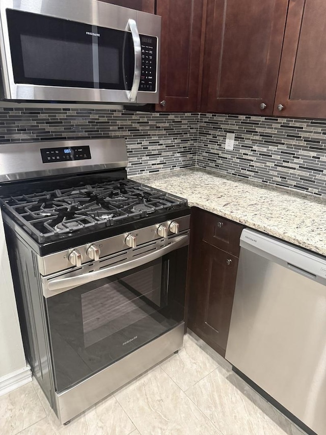 7929 S Manistee Ave, Chicago, IL 60617 - kitchen featuring stainless steel appliances, backsplash, dark brown cabinets, and light stone counters