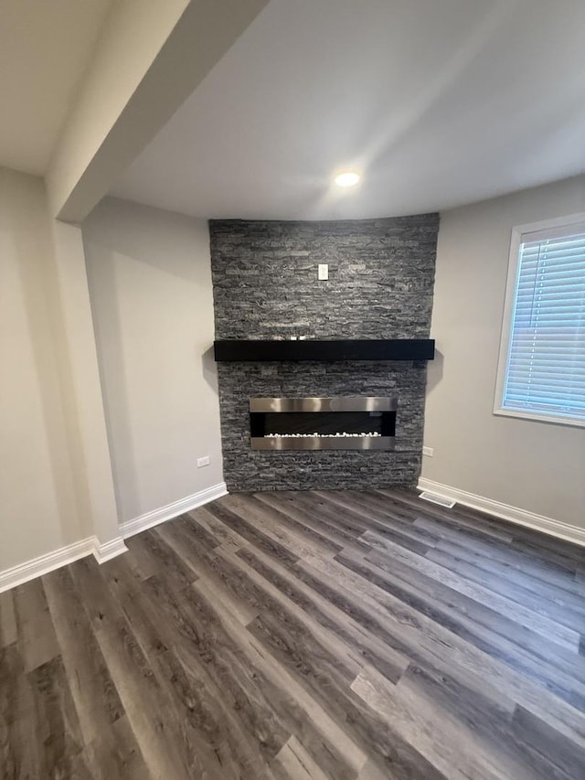 7929 S Manistee Ave, Chicago, IL 60617 - unfurnished living room with a stone fireplace and dark wood-type flooring