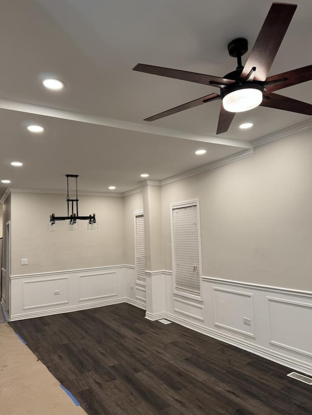 unfurnished room featuring wainscoting, ornamental molding, dark wood finished floors, and recessed lighting