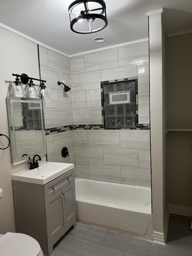full bathroom featuring crown molding, toilet, washtub / shower combination, vanity, and baseboards