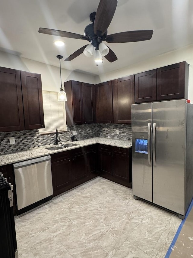 kitchen with stainless steel appliances, dark brown cabinets, a sink, and decorative backsplash