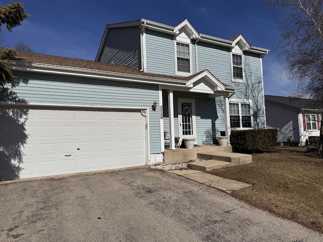 traditional-style home with aphalt driveway and an attached garage