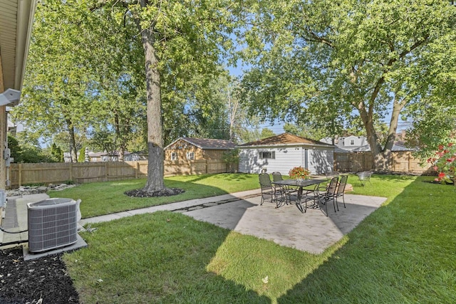 view of yard with a fenced backyard, a patio, cooling unit, and an outdoor structure