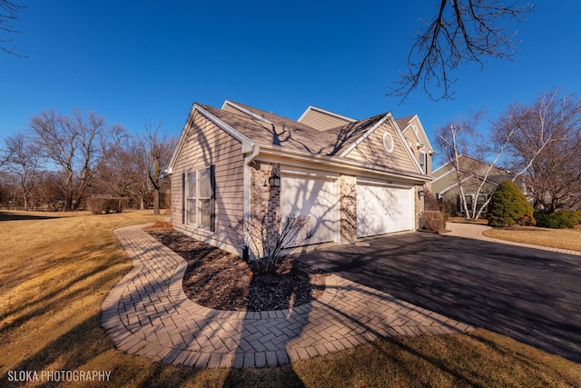 view of property exterior featuring driveway, an attached garage, and a lawn