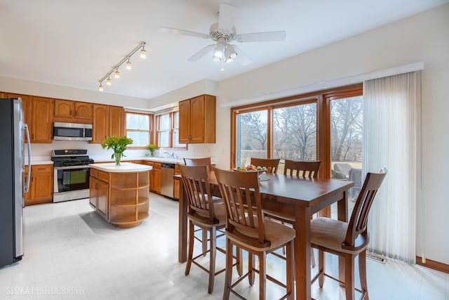 dining area featuring light floors and ceiling fan