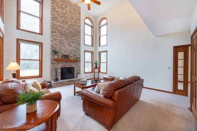 living room featuring high vaulted ceiling, a brick fireplace, and a wealth of natural light