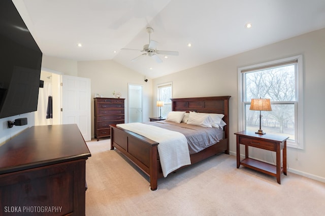 bedroom featuring vaulted ceiling, light carpet, a ceiling fan, and baseboards