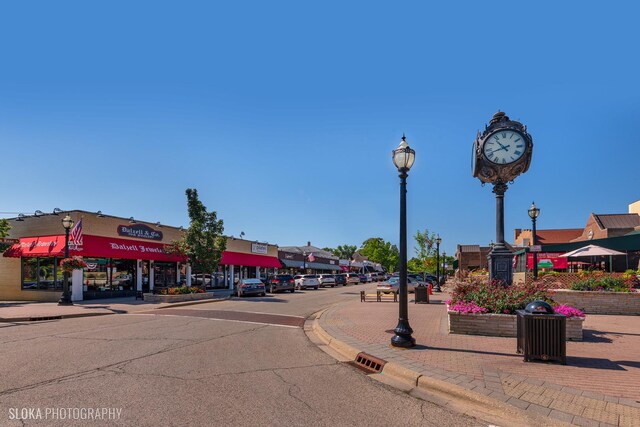 view of street featuring street lighting, curbs, and sidewalks